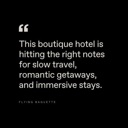 Black background with white text that reads: "This boutique hotel is hitting the right notes for slow travel, romantic getaways, and immersive stays." At the bottom, "FLYING BAGUETTE" appears in small capital letters.