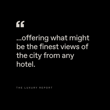 Black background with white text that reads: “…offering what might be the finest views of the city from any hotel.” Below, in smaller font, it says “The Luxury Report.”.
